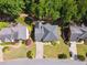 A bird's-eye view of a home featuring a dark roof, driveway, and manicured lawn at 320 Rossiter Rdg, Alpharetta, GA 30022