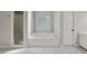 Bright bathroom features a shower and tub with tile flooring and natural light at 320 Rossiter Rdg, Alpharetta, GA 30022