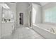 Bright bathroom features a tub, shower, double sinks and neutral tile floor at 320 Rossiter Rdg, Alpharetta, GA 30022