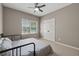 Neutral bedroom with a full size bed, carpeted floor, and natural light at 320 Rossiter Rdg, Alpharetta, GA 30022