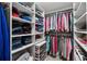 Walk-in closet with shelving and hanging rods for optimal organization at 320 Rossiter Rdg, Alpharetta, GA 30022