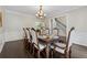 Formal dining room featuring hardwood floors, elegant chandelier, and ample seating at 320 Rossiter Rdg, Alpharetta, GA 30022