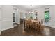 Open dining area with views to the living room and outdoor patio through french doors at 320 Rossiter Rdg, Alpharetta, GA 30022
