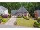 Traditional brick home with well-manicured lawn, two-car garage, and stately entrance at 320 Rossiter Rdg, Alpharetta, GA 30022
