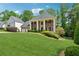 Beautiful landscaped lawn with a stately brick home featuring a three-car garage at 320 Rossiter Rdg, Alpharetta, GA 30022