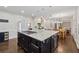 Spacious kitchen features a large center island with a gas cooktop, granite counters, and pendant lighting at 320 Rossiter Rdg, Alpharetta, GA 30022