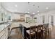 Open kitchen with a large island featuring bar seating, granite countertops, and updated stainless appliances at 320 Rossiter Rdg, Alpharetta, GA 30022
