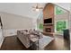 Cozy living room with vaulted ceilings, brick fireplace, large sectional sofa, and natural light at 320 Rossiter Rdg, Alpharetta, GA 30022