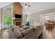 Spacious living room with brick fireplace, large windows, and connected dining and kitchen areas at 320 Rossiter Rdg, Alpharetta, GA 30022