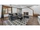 Comfortable living room with gray sofa, ottoman, patterned rug, and hardwood floors at 320 Rossiter Rdg, Alpharetta, GA 30022