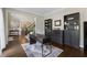 Spacious office with hardwood floors, large windows, and built-in shelving at 320 Rossiter Rdg, Alpharetta, GA 30022