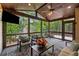 Screened-in porch with wood furniture and ceilings perfect for outdoor entertaining at 320 Rossiter Rdg, Alpharetta, GA 30022