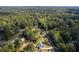 Aerial shot showcasing the home nestled amongst lush greenery and a picturesque neighborhood at 9770 Coleman Rd, Roswell, GA 30075