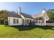 Well-maintained backyard with a lush lawn and a charming white exterior view of the home at 9770 Coleman Rd, Roswell, GA 30075