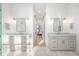 Dual vanities in a modern bathroom with marble countertops and sliding barn doors at 9770 Coleman Rd, Roswell, GA 30075