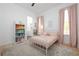 Bedroom with pink accents has a window and a bookshelf full of books at 9770 Coleman Rd, Roswell, GA 30075