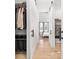 Walk-through closet with built-in shelving, rods, and drawers for organization at 9770 Coleman Rd, Roswell, GA 30075