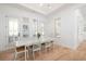 Bright dining room with natural light, hardwood floors, and white wood accents at 9770 Coleman Rd, Roswell, GA 30075
