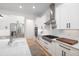 Spacious kitchen with white cabinets, stainless steel appliances, a large island, and hardwood floors at 9770 Coleman Rd, Roswell, GA 30075