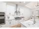 Well-equipped kitchen with white cabinetry, stainless steel appliances, and a functional center island at 9770 Coleman Rd, Roswell, GA 30075