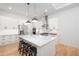 Modern kitchen featuring white cabinets, stainless steel appliances, and a marble island at 9770 Coleman Rd, Roswell, GA 30075