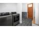 Laundry room with washer and dryer; includes a tiled shower at 9770 Coleman Rd, Roswell, GA 30075