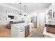 Open concept living area with a fireplace, built-in shelving, and access to kitchen at 9770 Coleman Rd, Roswell, GA 30075