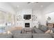 Bright living room featuring a fireplace, built-in shelving, a cozy gray sectional sofa, and access to the backyard at 9770 Coleman Rd, Roswell, GA 30075