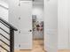 Walk-in pantry with shelving for ample storage, adjacent to hallway and staircase at 9770 Coleman Rd, Roswell, GA 30075