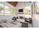 Bright sunroom featuring a brick fireplace, cozy seating, and large windows with scenic views at 9770 Coleman Rd, Roswell, GA 30075