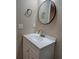 Stylish bathroom with a modern vanity, a round mirror, and fresh white countertops at 1356 Ambercrest Way, Austell, GA 30168