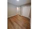 Comfortable bedroom featuring wood flooring, a closet with white doors, and an open doorway at 1356 Ambercrest Way, Austell, GA 30168