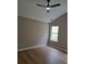 Bedroom with a ceiling fan, wood flooring and a bright window at 1356 Ambercrest Way, Austell, GA 30168