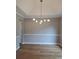 Spacious dining room with modern light fixture and beautiful crown molding at 1356 Ambercrest Way, Austell, GA 30168