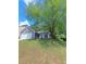 Cozy single-story home with gray siding, a two-car garage, and a tree-shaded front yard at 1356 Ambercrest Way, Austell, GA 30168