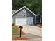 Charming home featuring a white garage door, grey siding, and well-maintained landscaping at 1356 Ambercrest Way, Austell, GA 30168