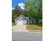 Cozy single-story home with gray siding, a two-car garage, and a well-manicured lawn at 1356 Ambercrest Way, Austell, GA 30168