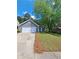 Charming single-story home with gray siding, a two-car garage, and a well-manicured lawn at 1356 Ambercrest Way, Austell, GA 30168