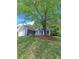 A charming single-story home with a well-manicured lawn and tree shaded yard at 1356 Ambercrest Way, Austell, GA 30168