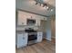 Modern kitchen with white cabinets, stainless steel appliances, and granite countertops at 1356 Ambercrest Way, Austell, GA 30168