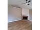 Open living room featuring a cozy fireplace and attractive wood-look flooring at 1356 Ambercrest Way, Austell, GA 30168