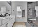 Elegant bathroom featuring double sinks, modern fixtures, and a glass-enclosed shower at 1386 Ben Park Way, Grayson, GA 30017