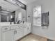 Bathroom featuring double sinks and vanities with white countertops, and dark hardware at 1386 Ben Park Way, Grayson, GA 30017