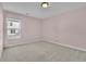 Cozy bedroom features plush carpeting and a window providing natural light at 1386 Ben Park Way, Grayson, GA 30017
