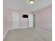 Cozy bedroom featuring carpet floors, light pink walls, and a mounted television at 1386 Ben Park Way, Grayson, GA 30017