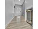 Bright hallway with light colored wood floors leading to the backyard door at 1386 Ben Park Way, Grayson, GA 30017