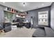 Office space with an L-shaped desk, a gray sofa, and an accent wall with shelves at 1386 Ben Park Way, Grayson, GA 30017