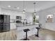 Modern kitchen with stainless steel appliances, granite countertops, and pendant lighting over the breakfast bar at 1386 Ben Park Way, Grayson, GA 30017