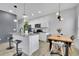 Kitchen features granite countertops, an island with seating, pendant lights, and a dining area at 1386 Ben Park Way, Grayson, GA 30017