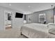 Spacious main bedroom featuring plush carpet, TV, and access to a large bathroom at 1386 Ben Park Way, Grayson, GA 30017